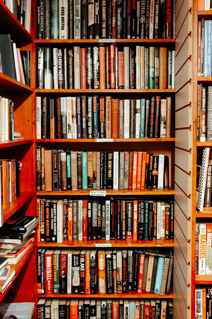 Vibrant bookshelf full of assorted books in a cozy library setting.